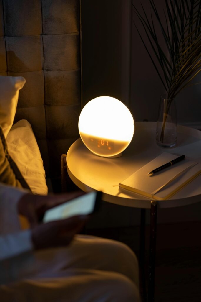 Warm bedside setting with a smart alarm clock and a cozy ambiance.